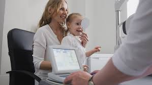 Mother and child taking eye exam