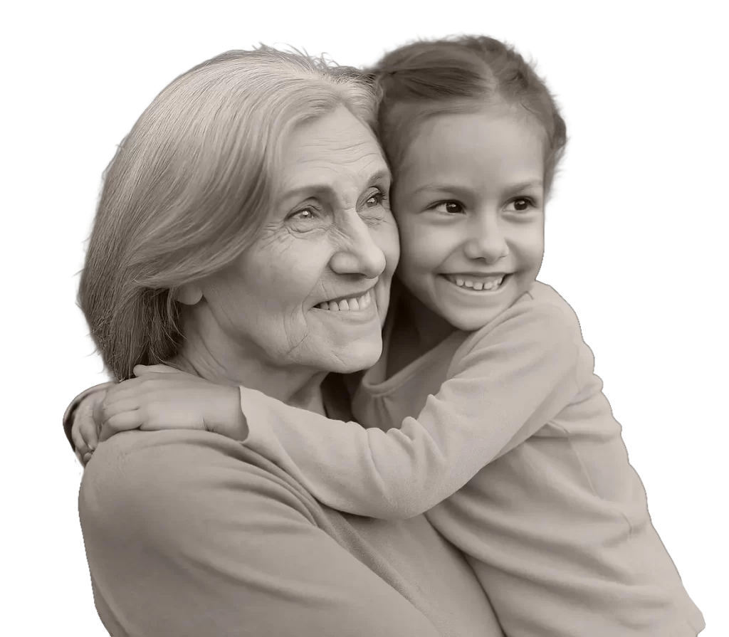 An older woman smiling and embracing a young girl, both looking happy and content, symbolizing clear vision and connection across generations at Katmai Eye and Vision Center.